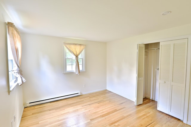 792 Cornwall Ave, Cheshire, CT 06410 - unfurnished bedroom with a baseboard radiator, light wood-style flooring, a closet, and baseboards