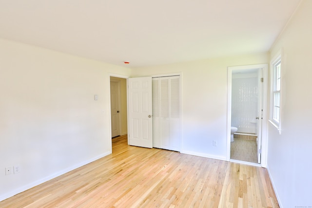 792 Cornwall Ave, Cheshire, CT 06410 - unfurnished bedroom with light wood finished floors, baseboards, a closet, and connected bathroom