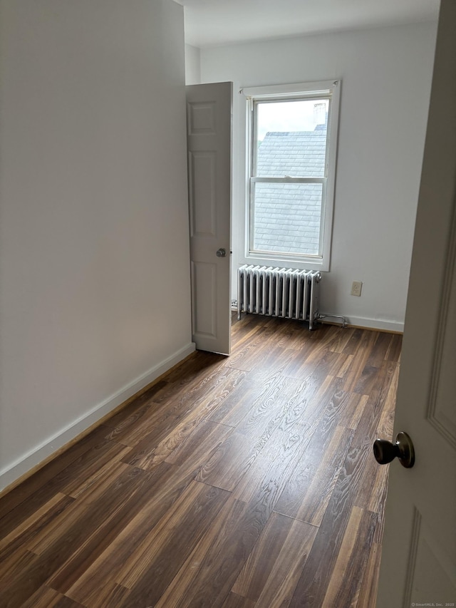 70 W St, New London, CT 06320 - unfurnished room featuring radiator heating unit, dark wood-type flooring, and baseboards