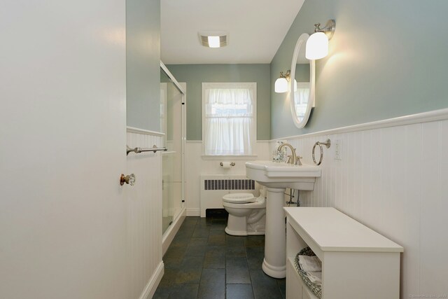 110 Cottage St, Trumbull, CT 06611 - bathroom featuring radiator, toilet, a stall shower, a wainscoted wall, and stone finish flooring