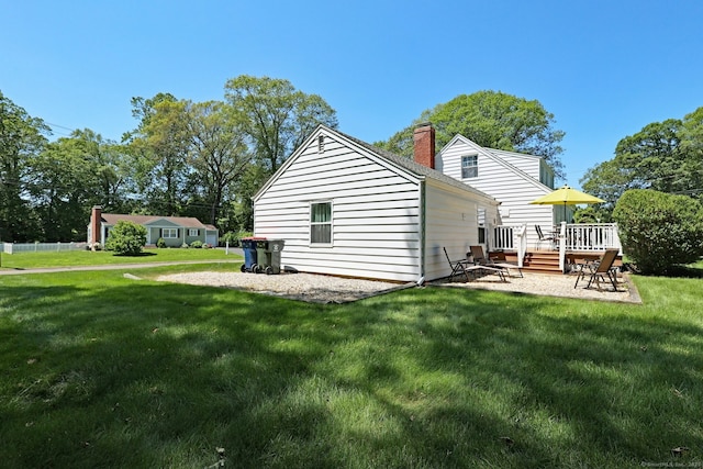 110 Cottage St, Trumbull, CT 06611 - back of property featuring a wooden deck, a lawn, and a chimney