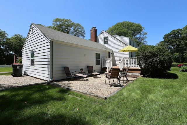 110 Cottage St, Trumbull, CT 06611 - back of house with a chimney, a lawn, a patio area, a deck, and roof with shingles