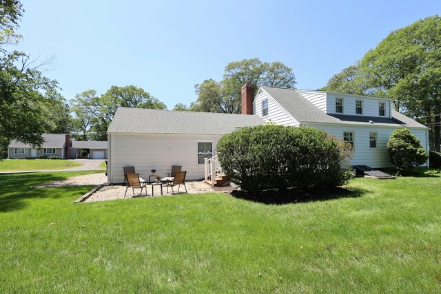 110 Cottage St, Trumbull, CT 06611 - back of property featuring a chimney, a yard, and a patio area