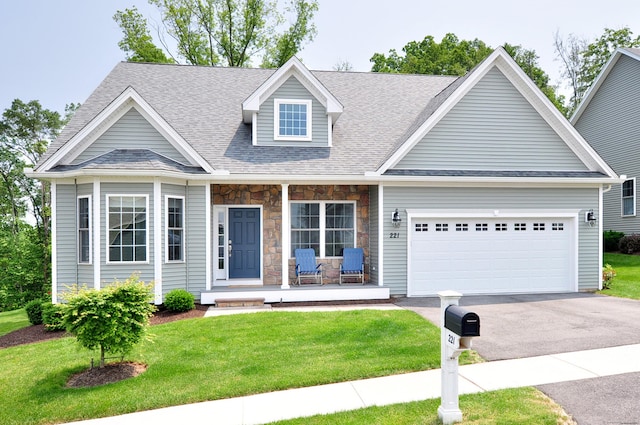 221 Scenic Dr Unit 221, Berlin, CT 06037 - view of front of house with a porch, asphalt driveway, a garage, a front yard, and roof with shingles