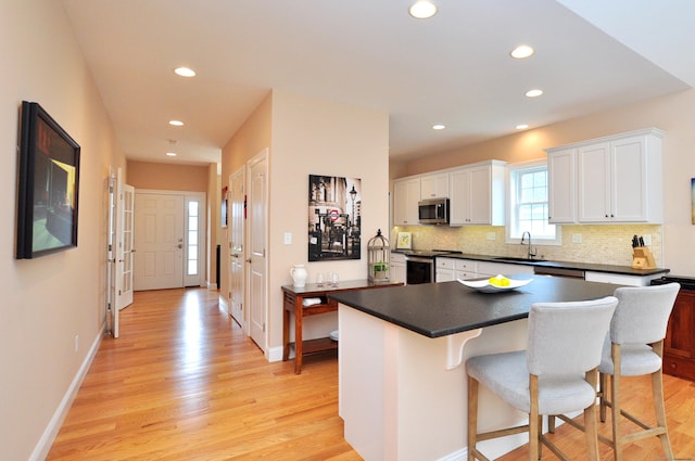 221 Scenic Dr Unit 221, Berlin, CT 06037 - kitchen with appliances with stainless steel finishes, dark countertops, white cabinets, recessed lighting, and tasteful backsplash