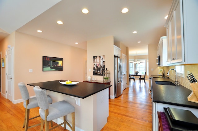 221 Scenic Dr Unit 221, Berlin, CT 06037 - kitchen featuring appliances with stainless steel finishes, dark countertops, white cabinets, a kitchen breakfast bar, and recessed lighting