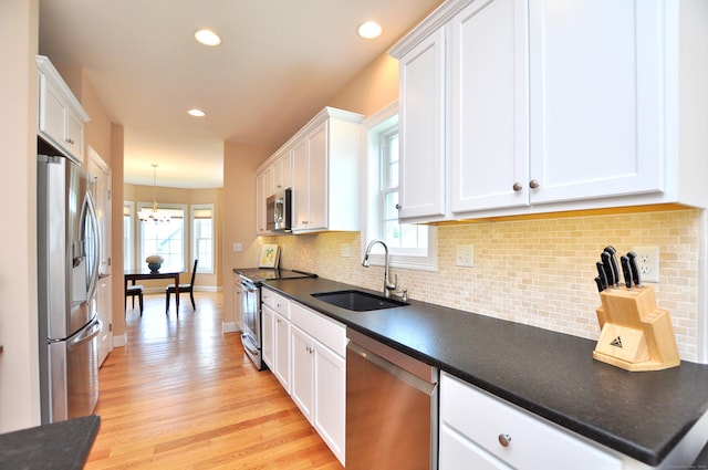 221 Scenic Dr Unit 221, Berlin, CT 06037 - kitchen featuring appliances with stainless steel finishes, a chandelier, white cabinetry, and recessed lighting