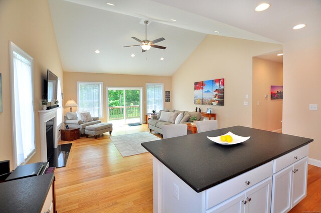 221 Scenic Dr Unit 221, Berlin, CT 06037 - kitchen featuring light wood-style floors, dark countertops, white cabinetry, a ceiling fan, and a fireplace