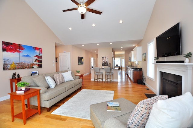 221 Scenic Dr Unit 221, Berlin, CT 06037 - living room with high vaulted ceiling, ceiling fan, light wood finished floors, a glass covered fireplace, and recessed lighting