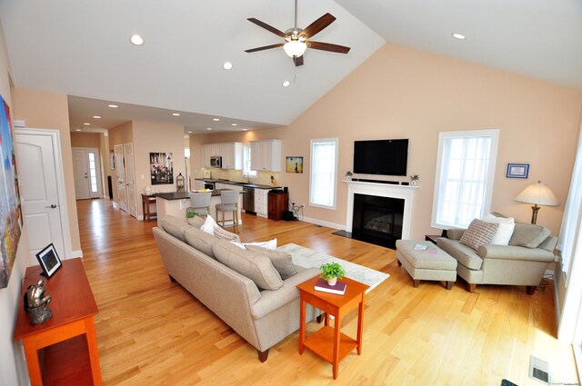 221 Scenic Dr Unit 221, Berlin, CT 06037 - living area with high vaulted ceiling, ceiling fan, light wood-style floors, a fireplace with flush hearth, and recessed lighting
