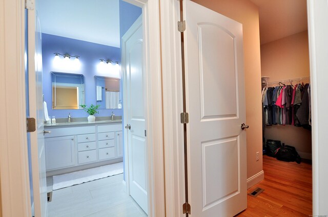 221 Scenic Dr Unit 221, Berlin, CT 06037 - corridor with a sink and light wood-style floors