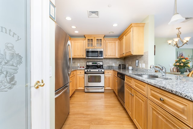 237 Fern St Apt 206W, West Hartford, CT 06119 - kitchen with appliances with stainless steel finishes, a chandelier, light brown cabinets, a sink, and light wood-style floors