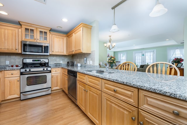 237 Fern St Apt 206W, West Hartford, CT 06119 - kitchen with appliances with stainless steel finishes, a sink, plenty of natural light, recessed lighting, and decorative backsplash