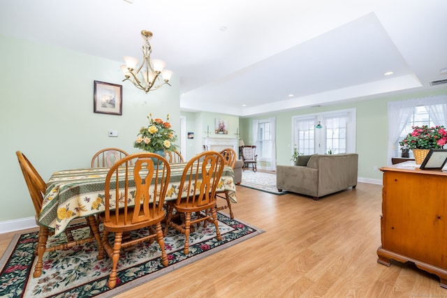 237 Fern St Apt 206W, West Hartford, CT 06119 - dining room with a chandelier, light wood finished floors, a raised ceiling, baseboards, and recessed lighting