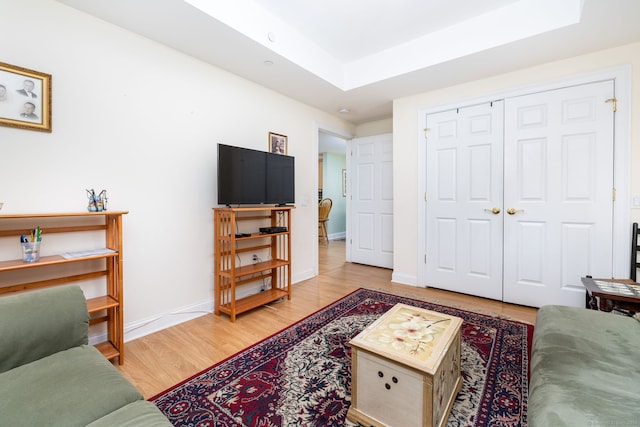 237 Fern St Apt 206W, West Hartford, CT 06119 - living room featuring wood finished floors, baseboards, and a raised ceiling