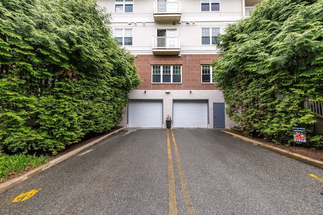237 Fern St Apt 206W, West Hartford, CT 06119 - view of building exterior with asphalt driveway and a garage