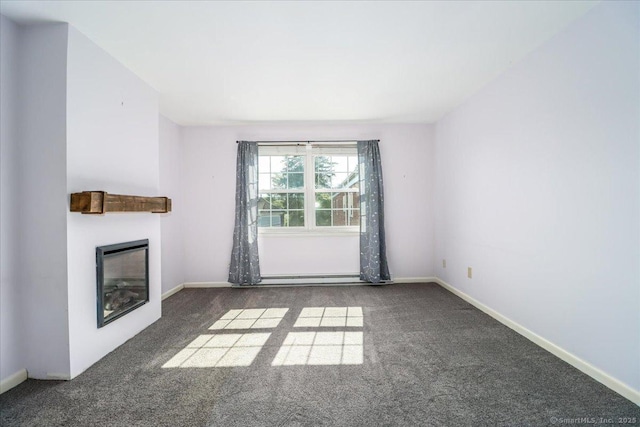 12 Terrace Pl Unit 12, New Milford, CT 06776 - unfurnished living room featuring carpet flooring, a glass covered fireplace, a baseboard radiator, and baseboards
