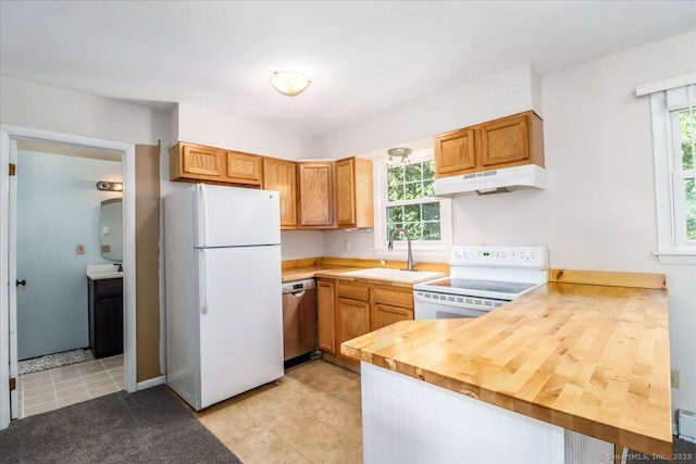12 Terrace Pl Unit 12, New Milford, CT 06776 - kitchen with white appliances, under cabinet range hood, a sink, a peninsula, and plenty of natural light