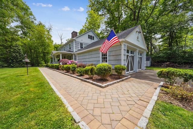 6 Downe Ln, Wilton, CT 06897 - view of front of property with a front lawn, a chimney, and roof with shingles