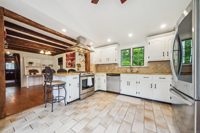 6 Downe Ln, Wilton, CT 06897 - kitchen with appliances with stainless steel finishes, island range hood, a ceiling fan, a peninsula, and recessed lighting