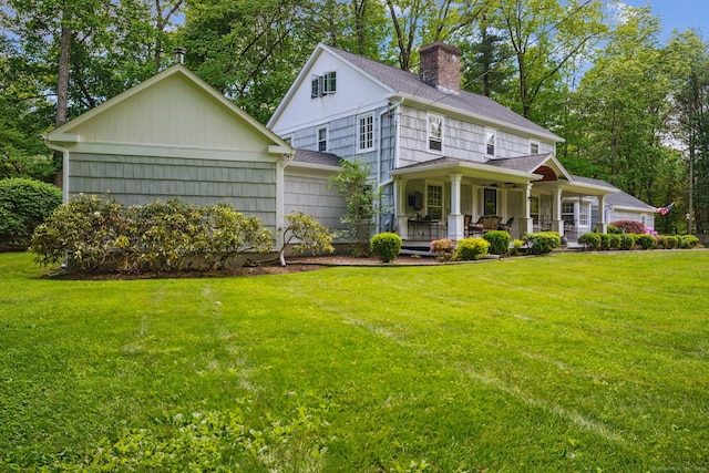 6 Downe Ln, Wilton, CT 06897 - view of front facade featuring a chimney, a porch, a front yard, and a garage