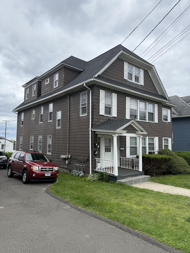 290 Ridgefield Ave, Bridgeport, CT 06610 - townhome / multi-family property featuring covered porch, a shingled roof, a front lawn, and cooling unit