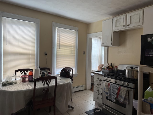 290 Ridgefield Ave, Bridgeport, CT 06610 - kitchen with stainless steel range with gas cooktop, a baseboard heating unit, and light tile patterned floors