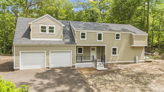 73 Nedobity Rd, Haddam, CT 06441 - view of front of home with driveway, a porch, a garage, and view of scattered trees