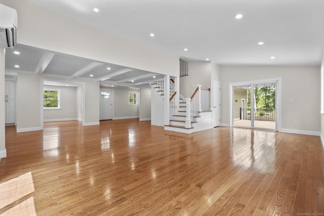 73 Nedobity Rd, Haddam, CT 06441 - unfurnished living room with a wall unit AC, stairway, recessed lighting, light wood-style floors, and baseboards