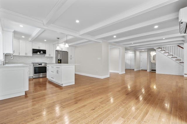 73 Nedobity Rd, Haddam, CT 06441 - kitchen featuring stainless steel appliances, open floor plan, a sink, beam ceiling, and light wood finished floors
