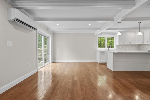 73 Nedobity Rd, Haddam, CT 06441 - unfurnished living room featuring a wall mounted air conditioner, light wood-style flooring, beam ceiling, baseboards, and recessed lighting