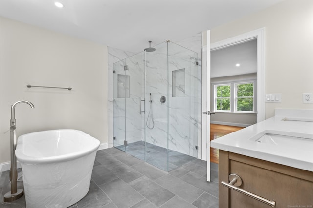 73 Nedobity Rd, Haddam, CT 06441 - full bath with a marble finish shower, a soaking tub, double vanity, baseboards, and recessed lighting