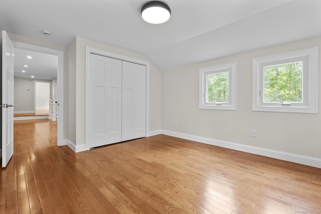 73 Nedobity Rd, Haddam, CT 06441 - unfurnished bedroom with light wood-style floors, baseboards, lofted ceiling, and a closet