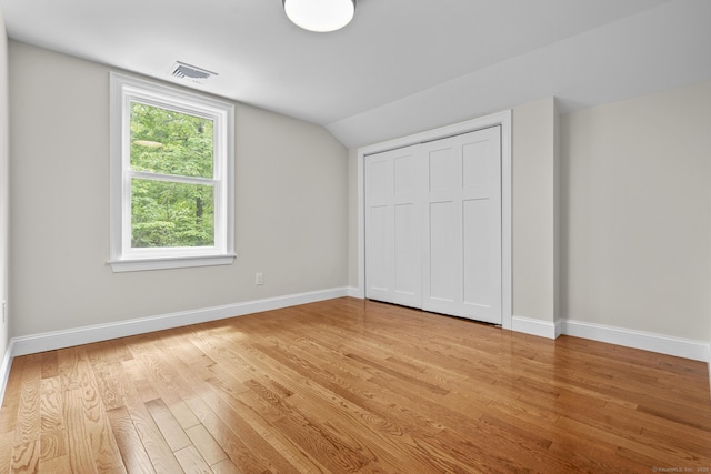 73 Nedobity Rd, Haddam, CT 06441 - unfurnished bedroom with light wood-type flooring, vaulted ceiling, baseboards, and a closet