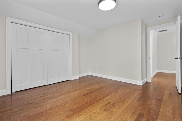 73 Nedobity Rd, Haddam, CT 06441 - unfurnished bedroom with wood finished floors, baseboards, lofted ceiling, and a closet