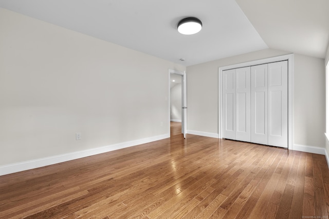 73 Nedobity Rd, Haddam, CT 06441 - unfurnished bedroom with wood-type flooring, baseboards, a closet, and lofted ceiling