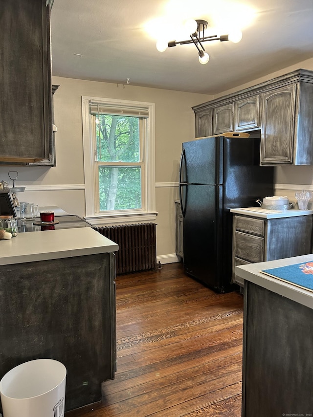 146 Knowlton St, Stratford, CT 06615 - kitchen with radiator heating unit, freestanding refrigerator, dark wood-style floors, and light countertops