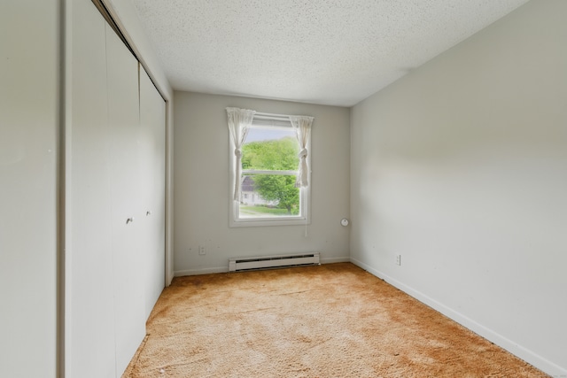 23 Fenwick Ct, Groton, CT 06355 - unfurnished bedroom featuring baseboard heating, carpet floors, a closet, a textured ceiling, and baseboards
