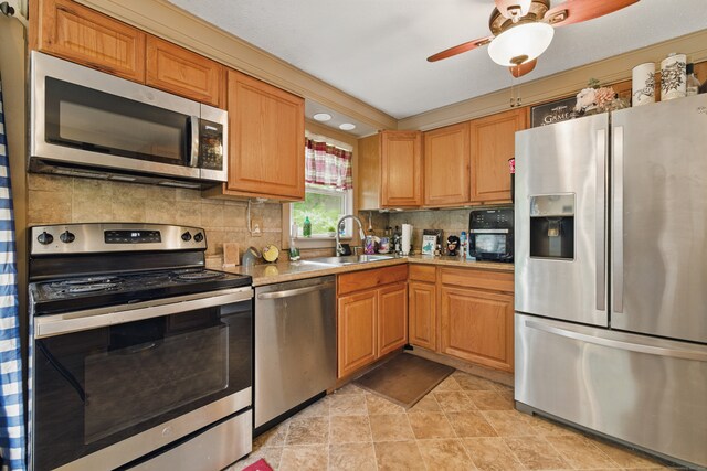 23 Fenwick Ct, Groton, CT 06355 - kitchen featuring appliances with stainless steel finishes, a sink, tasteful backsplash, ceiling fan, and light countertops