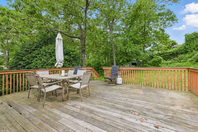 23 Fenwick Ct, Groton, CT 06355 - wooden deck with outdoor dining area and view of wooded area
