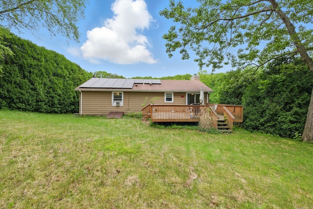 23 Fenwick Ct, Groton, CT 06355 - rear view of house featuring a yard, a deck, solar panels, and a chimney