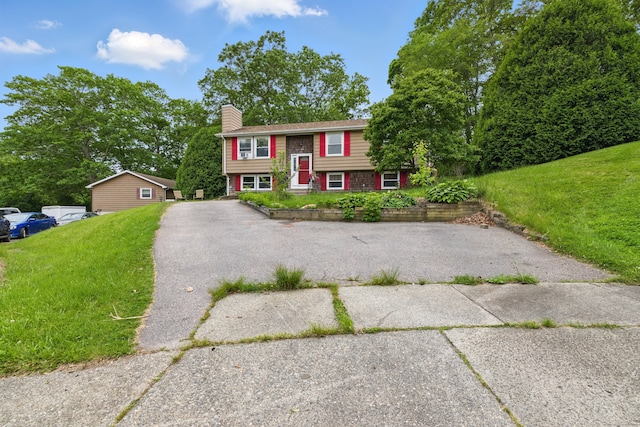23 Fenwick Ct, Groton, CT 06355 - raised ranch with a chimney, a front yard, and asphalt driveway