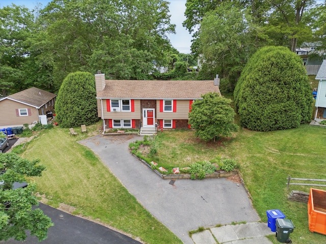 23 Fenwick Ct, Groton, CT 06355 - split foyer home featuring a chimney, driveway, and a front lawn