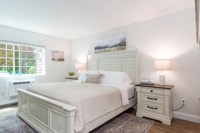 2955 Madison Ave Apt 25, Bridgeport, CT 06606 - bedroom with light wood-type flooring, baseboards, and a wall unit AC