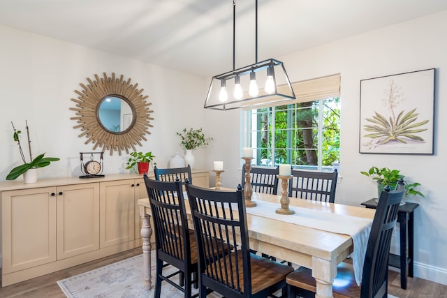 2955 Madison Ave Apt 25, Bridgeport, CT 06606 - dining area with light wood-style floors, a chandelier, and baseboards