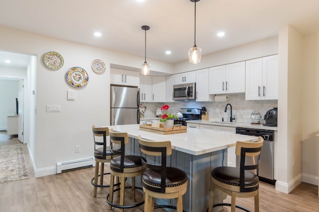 2955 Madison Ave Apt 25, Bridgeport, CT 06606 - kitchen featuring appliances with stainless steel finishes, a baseboard radiator, a sink, a kitchen breakfast bar, and recessed lighting