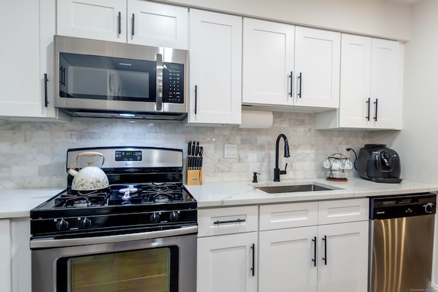 2955 Madison Ave Apt 25, Bridgeport, CT 06606 - kitchen with stainless steel appliances, a sink, and white cabinetry