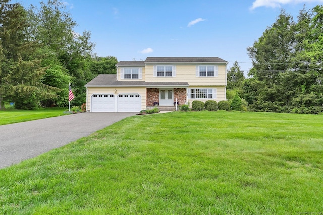 31 Elizabeth St, Shelton, CT 06484 - view of front of property featuring french doors, a front yard, driveway, and an attached garage