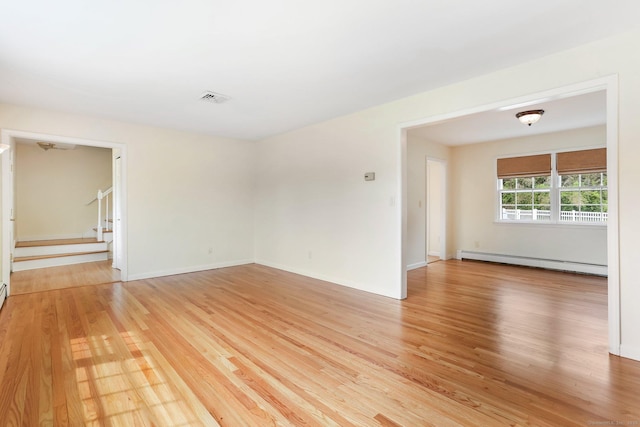 31 Elizabeth St, Shelton, CT 06484 - spare room with a baseboard radiator, light wood finished floors, stairs, and baseboards