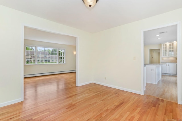 31 Elizabeth St, Shelton, CT 06484 - spare room with baseboard heating, light wood-type flooring, and baseboards